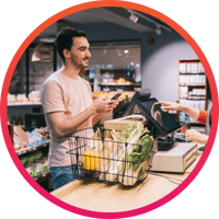 Man paying for groceries at checkout with gift card
