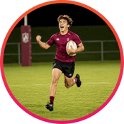 Rugby player running across field