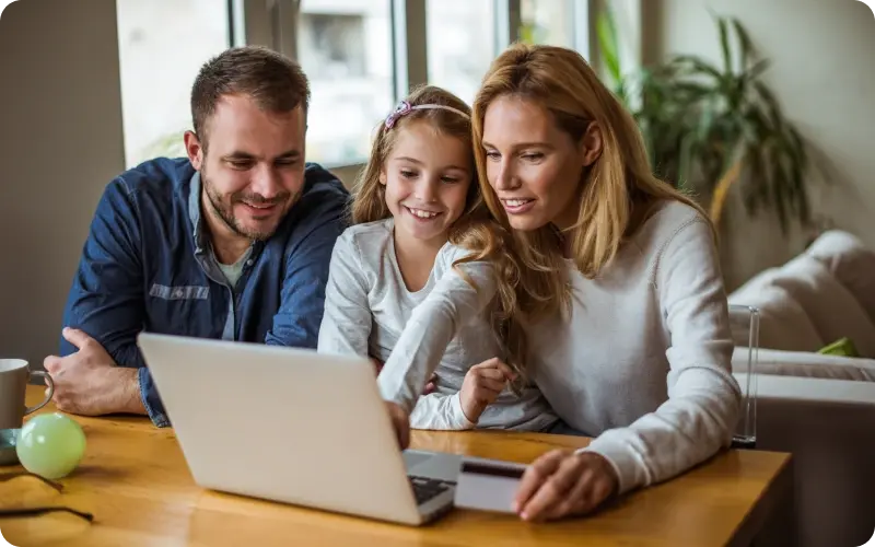 Girl and parents at computer