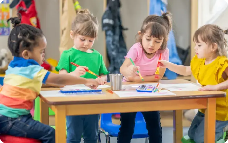 preschool kids working at a table