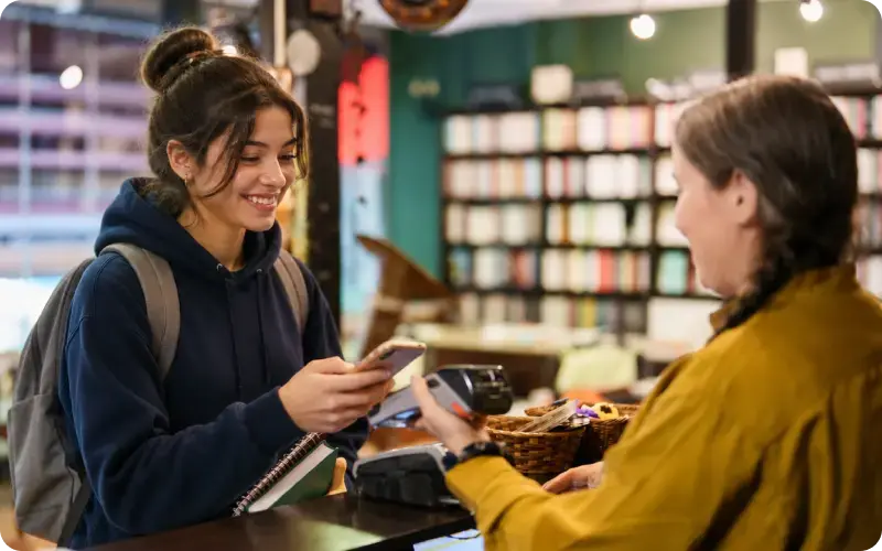 student checking out at a bookstore